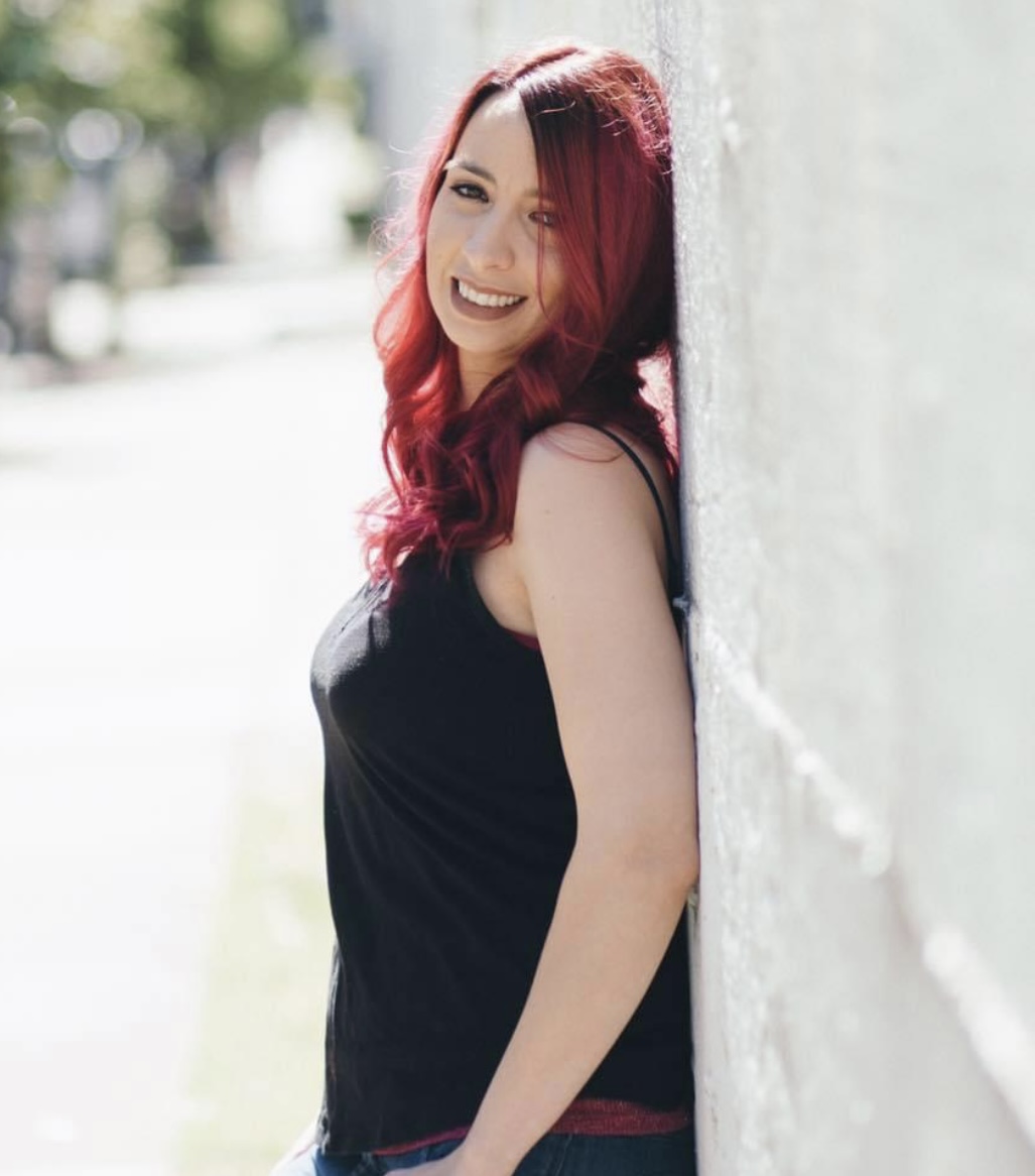 Amy smiling with vivid red hair