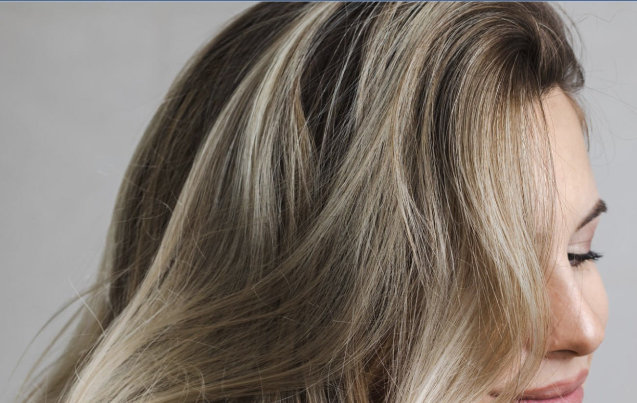 Soft blonde balayage dimension through the face frame