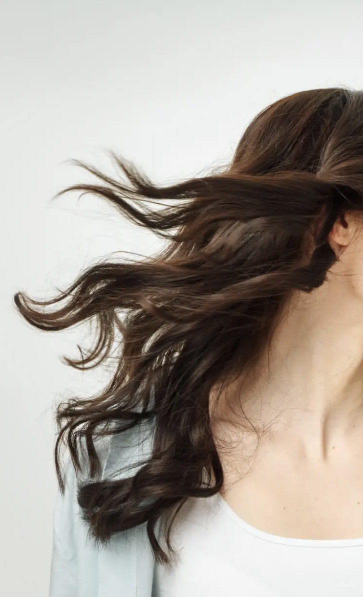 Smooth brunette hair styled with a polished finish