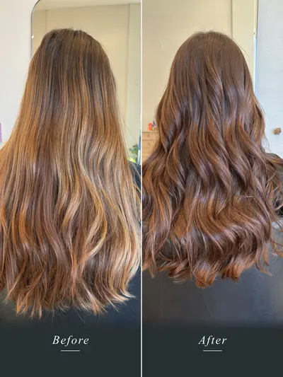 Before and after: long hair with uneven, brassy orange ends corrected to a warm, even chestnut brunette with soft waves.